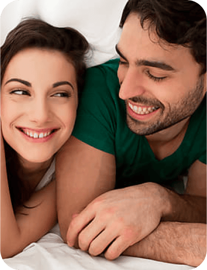 young man and woman smiling and leaning forward