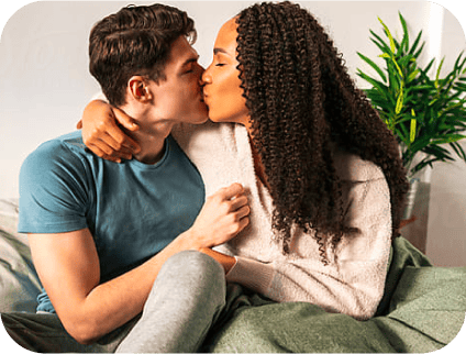 Young man and woman kissing on the couch