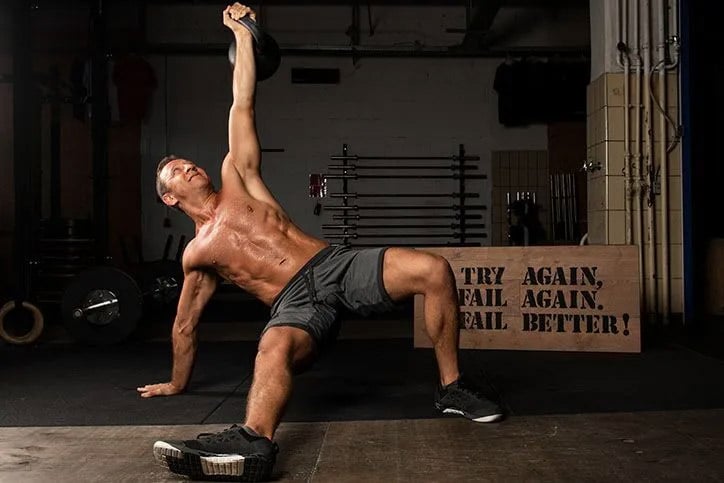 Man on the floor doing kegel exercise