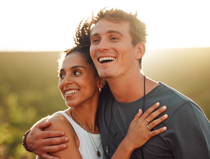Love, countryside and couple smile, smile and bonding together on a sunny wine farm field and nature agriculture.