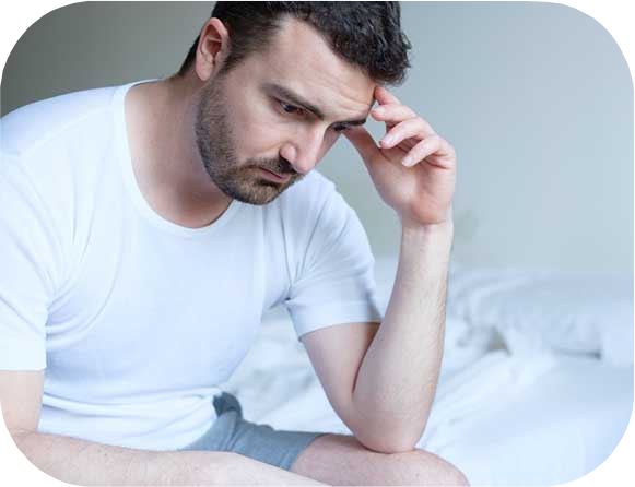 Sad and upset man waking up in the morning light