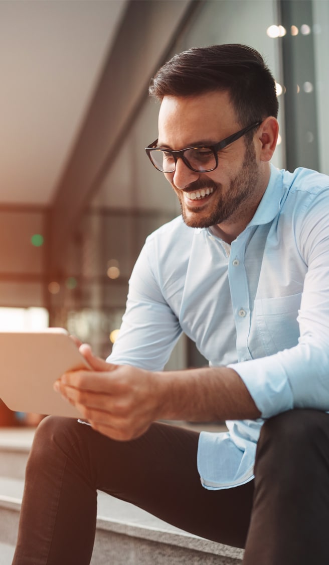 Portrait of businessman in glasses holding tablet