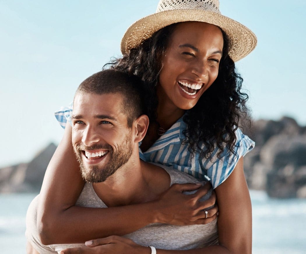 Romance, ocean and piggy back, happy couple with blue sky on romantic summer holiday travel to beach.