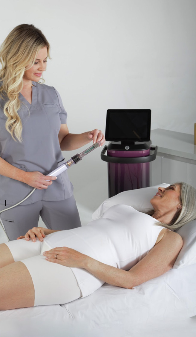 Female medical practitioner standing over an older female patient Female medical practitioner standing over an older female patient